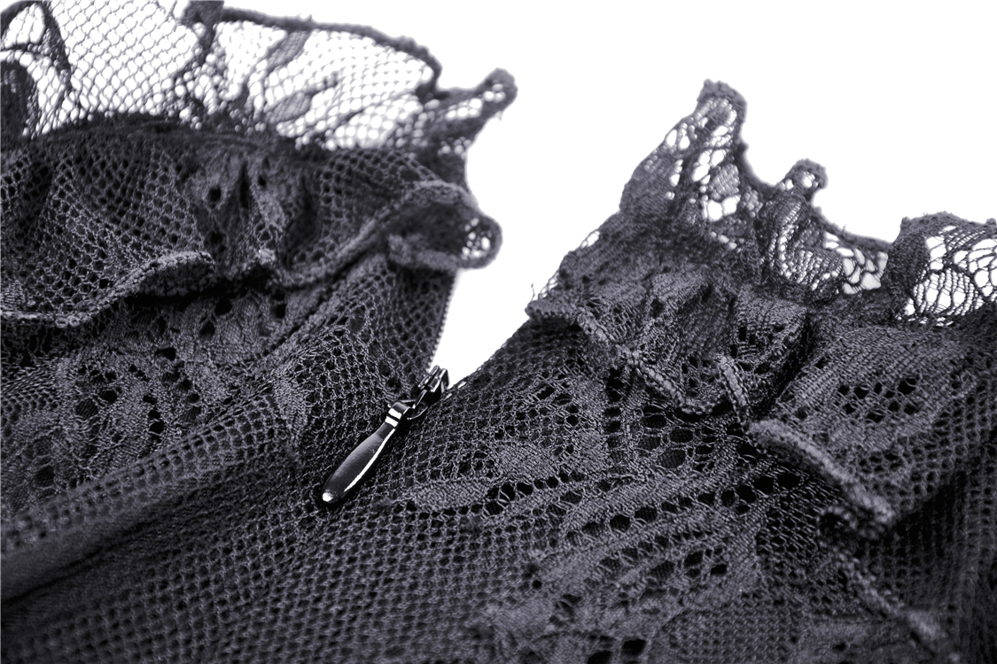 Close-up of dark lace detailing on an off-the-shoulder dress, showcasing intricate patterns and elegant ruffles.