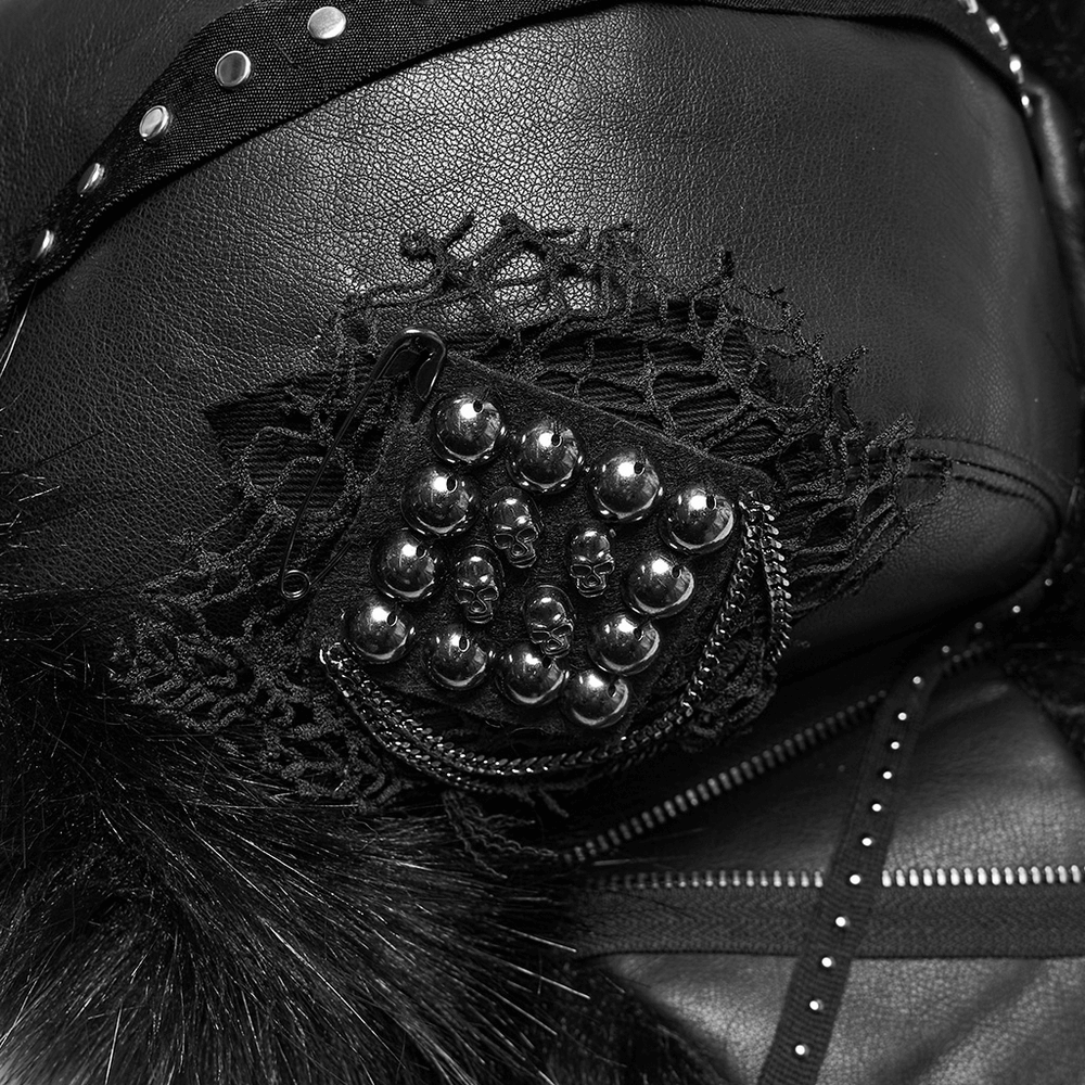 Close-up of dark plush punk hat with tattered mesh, metal skull accents, and faux fur, showcasing its rebellious style.