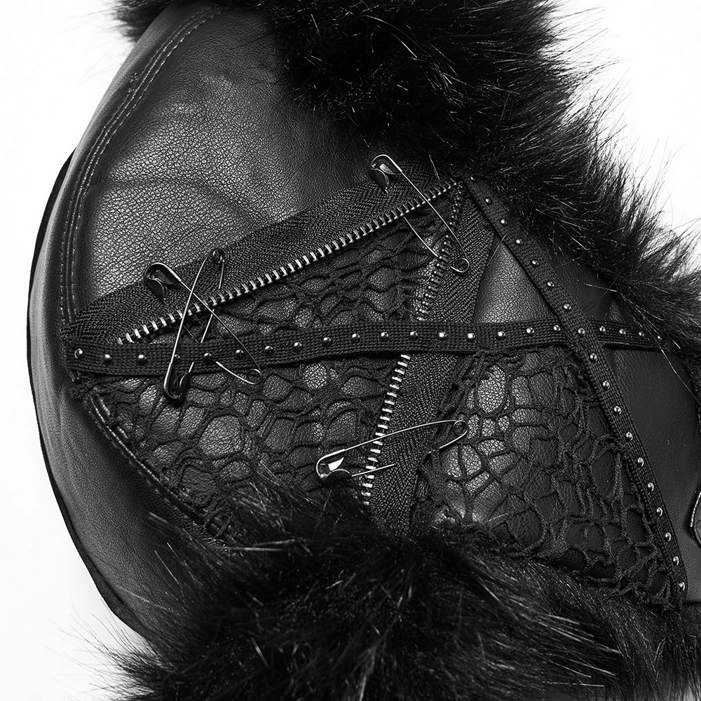 Close-up of a dark plush punk hat featuring tattered mesh, studs, and safety pins for a bold, edgy look.