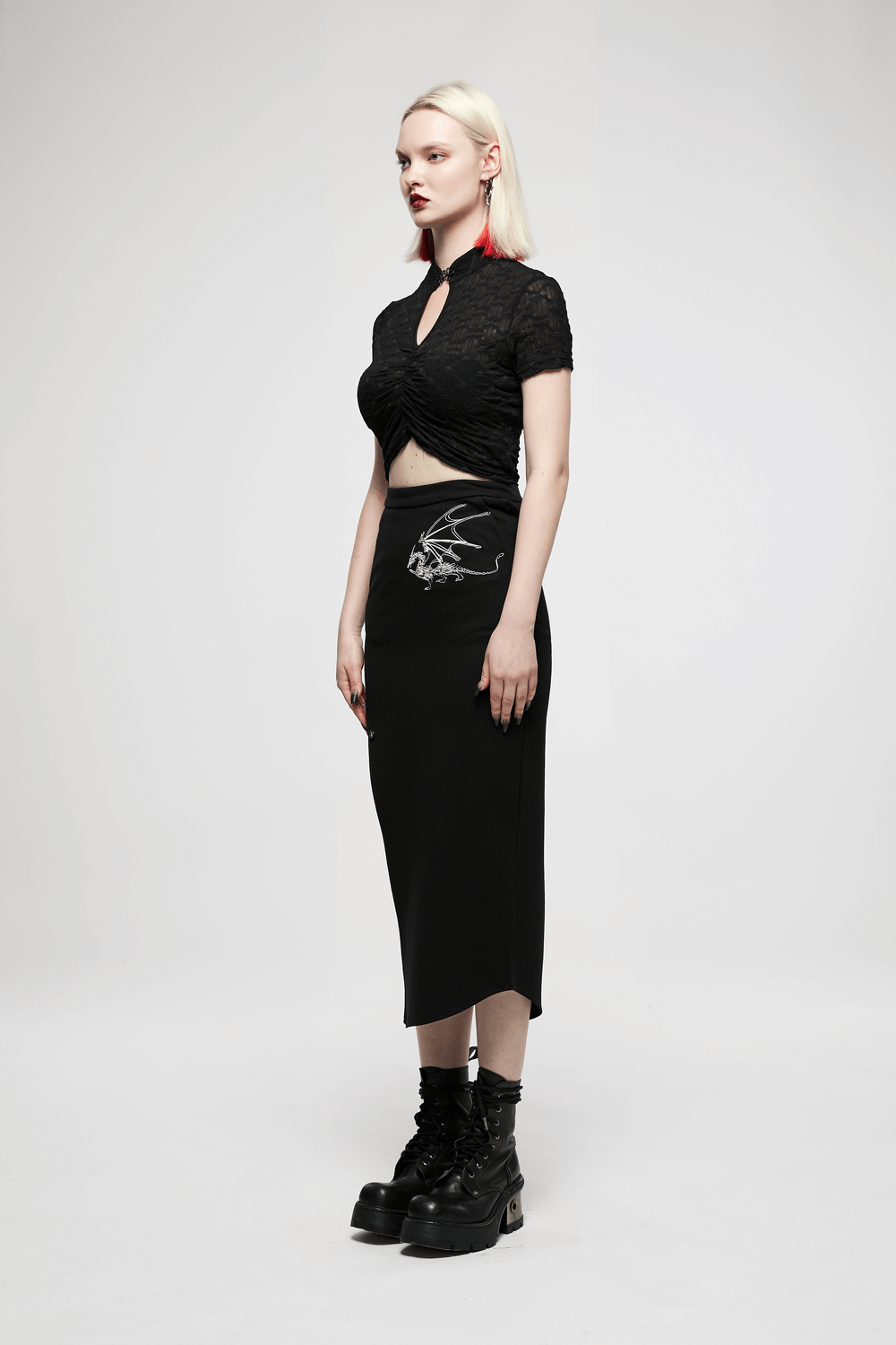 Model wearing a black asymmetric pencil skirt with dragon embroidery and a stylish crop top, showcasing punk fashion.