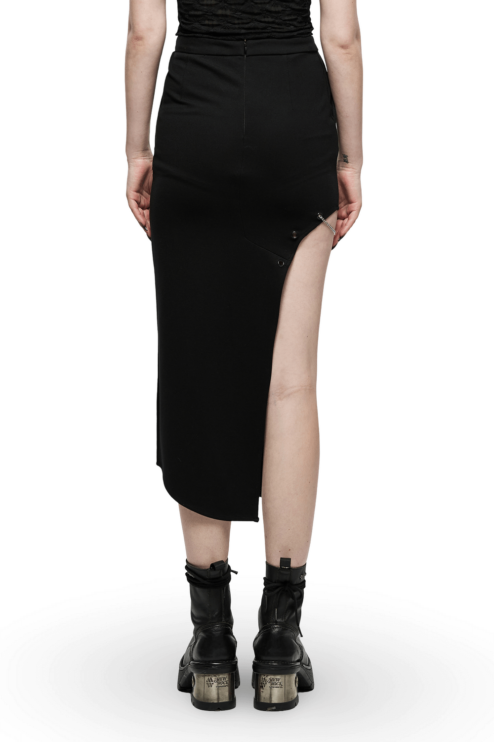 Back view of a dark punk asymmetric skirt featuring a side slit and stylish eyelets, paired with edgy black boots.