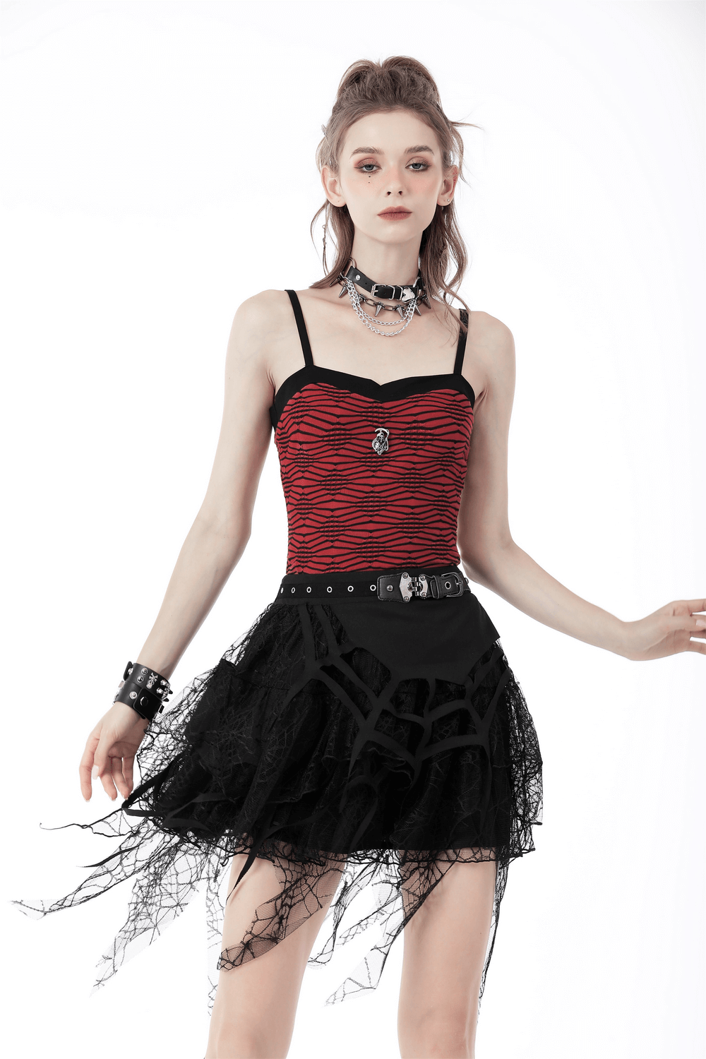 Model showcasing a Dark Punk Lace Spiderweb Mini Skirt with a red striped top and edgy accessories.