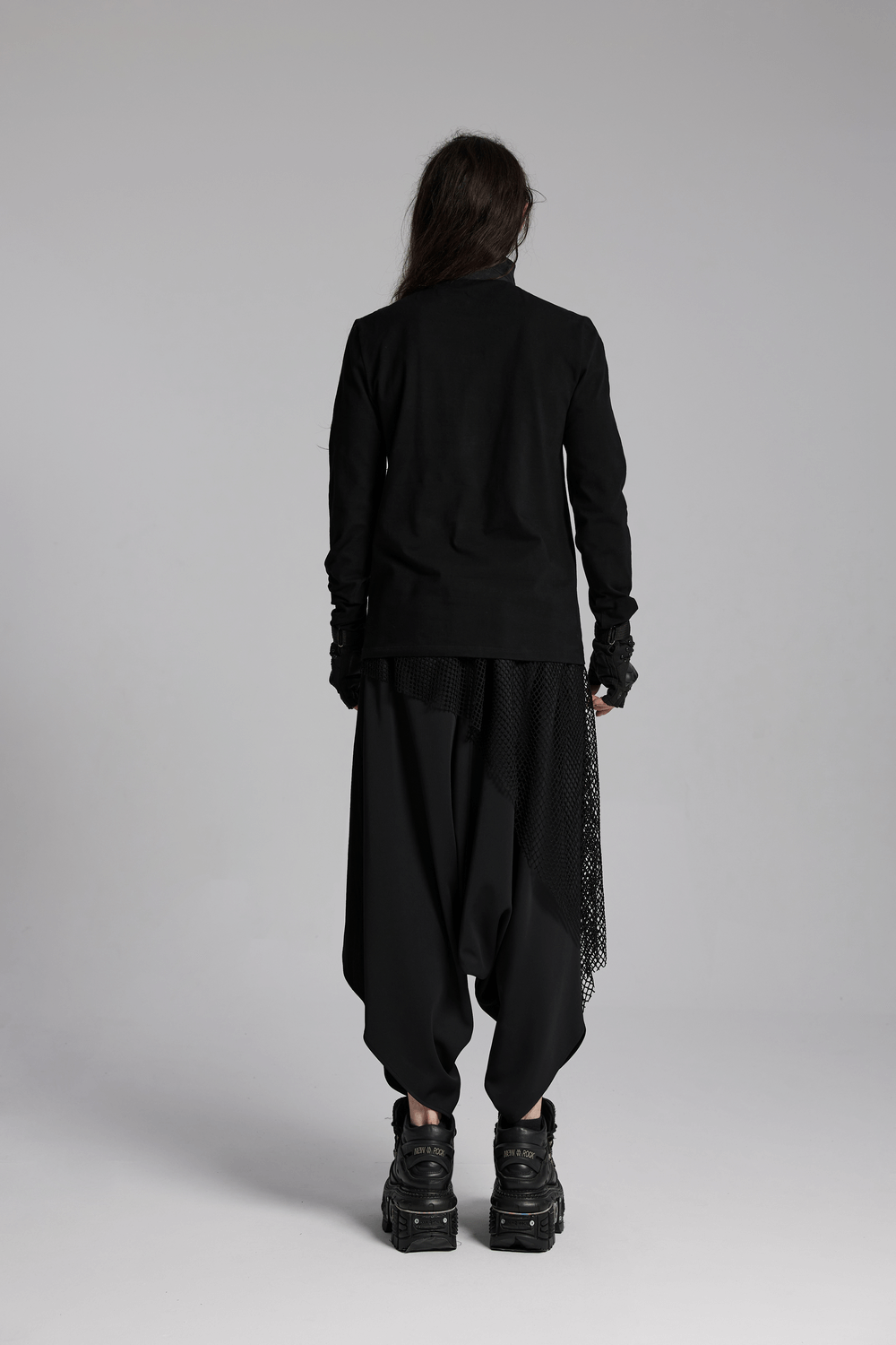 Model wearing dark punk loose fit harem pants with mesh layers and a black top, showcasing a high-street aesthetic.