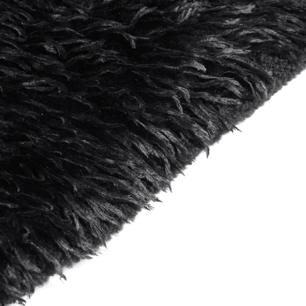 Dark Punk Overcoat with Spiked Shoulders and Pointed Hem, close-up of shaggy black trim