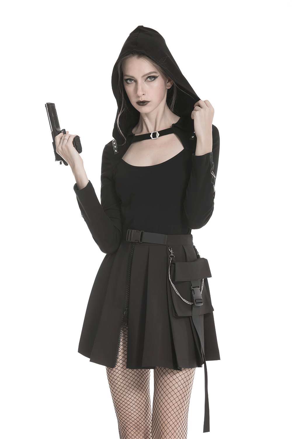 Edgy model in a black hoodie holding a gun, wearing a dark punk pleated mini skirt with chain detail.