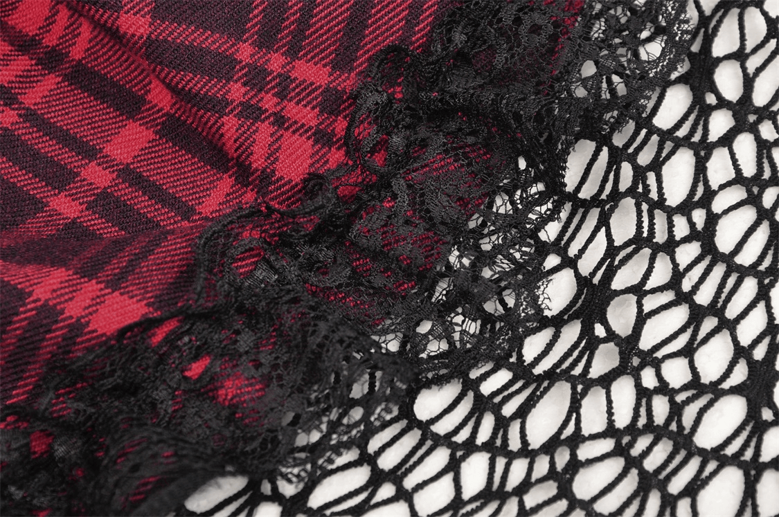 Close-up of red and black plaid fabric paired with delicate black lace for a goth-inspired look.
