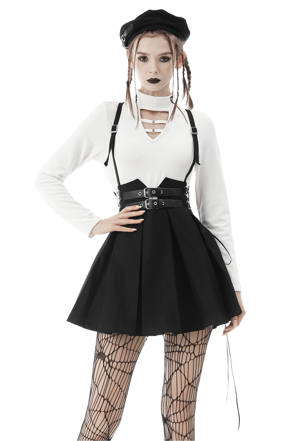 Gothic model wearing a Dark Punk Suspender Skirt with buckle detailing, paired with a stylish top and fishnet stockings.