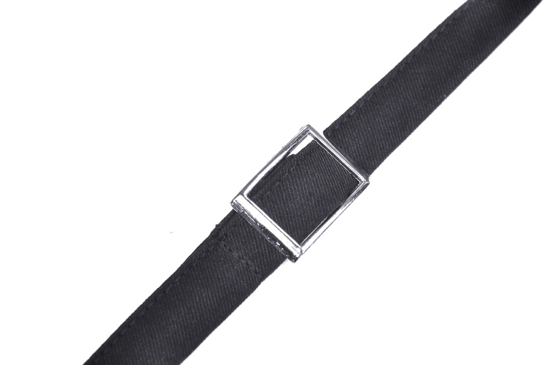 Close-up of a black suspender strap with shiny silver buckle detail for a gothic skirt.