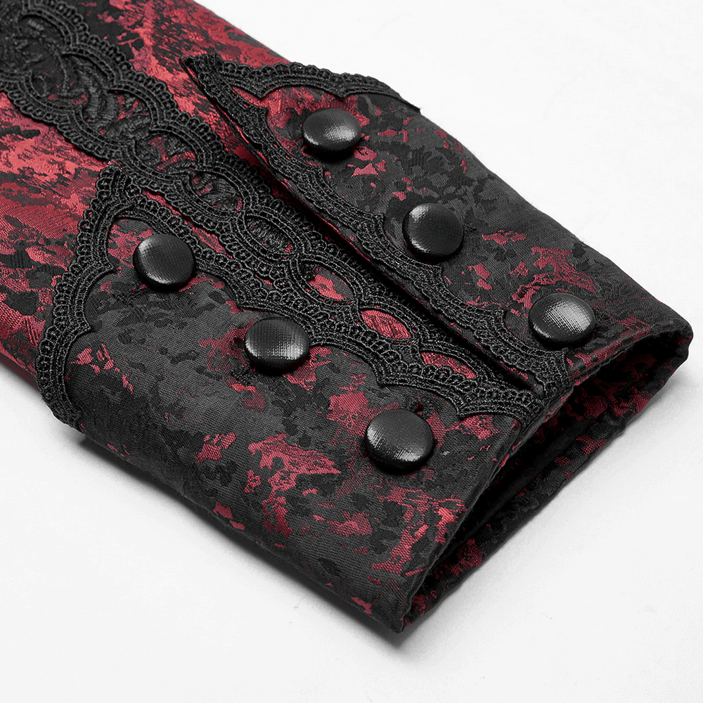 Close-up of the sleeve of a dark red and black rococo lace tuxedo coat with intricate lace detailing and black buttons.