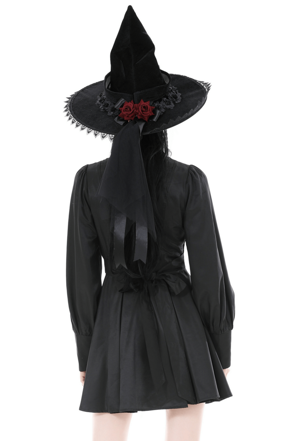 Back view of a model in a black ruffled neckline dress and witch hat with roses, showcasing gothic elegance.