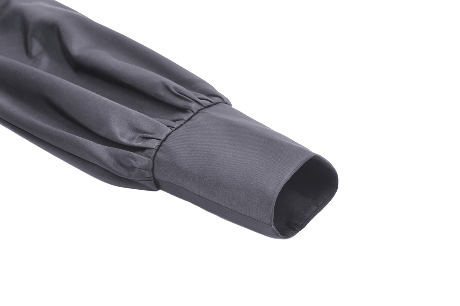 Close-up of a long-sleeved dress sleeve with ruffle detailing and elegant black fabric.