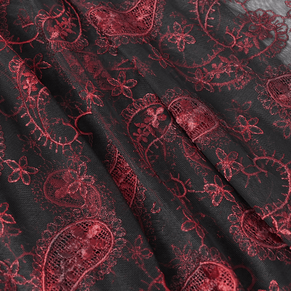 Close-up of dark romantic embroidered lace veil featuring rich wine red paisley designs on sheer black mesh.