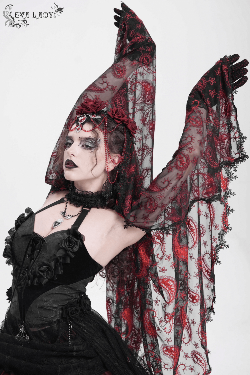 Dark romantic gothic model showcasing embroidered lace veil with skull pendant and red roses, perfect for alternative fashion.