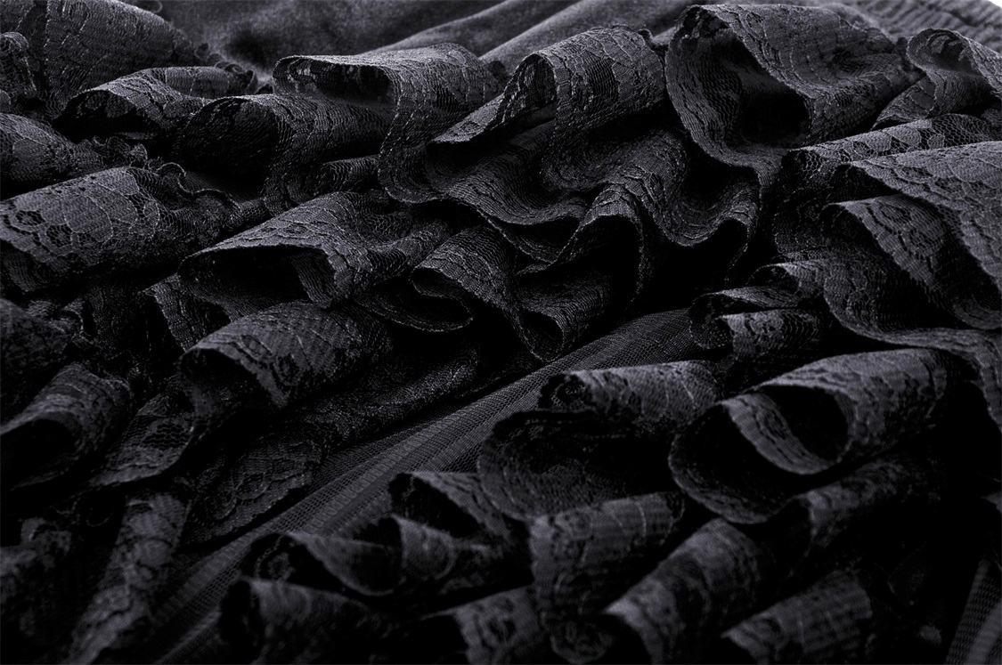 Close-up of black lace ruffles, showcasing the intricate texture of a dark romantic gothic high-low skirt.