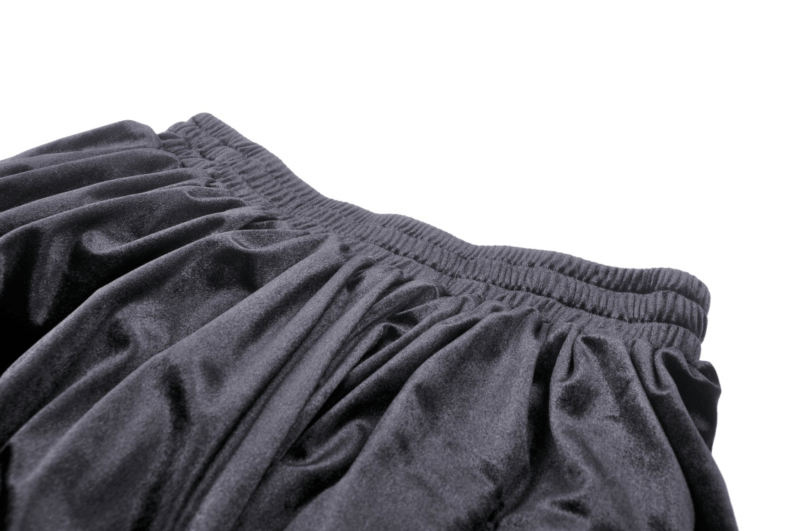 Close-up of dark romantic goth women's lace skirt, showcasing ruffled fabric and high-waisted design.