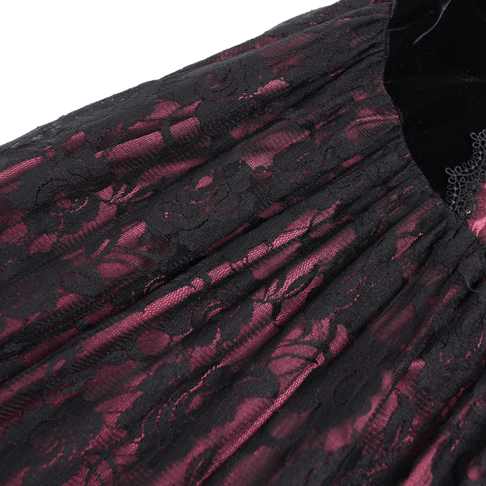 Close-up of dark romantic gothic gown featuring black lace with wine red velvet details and floral embroidery.