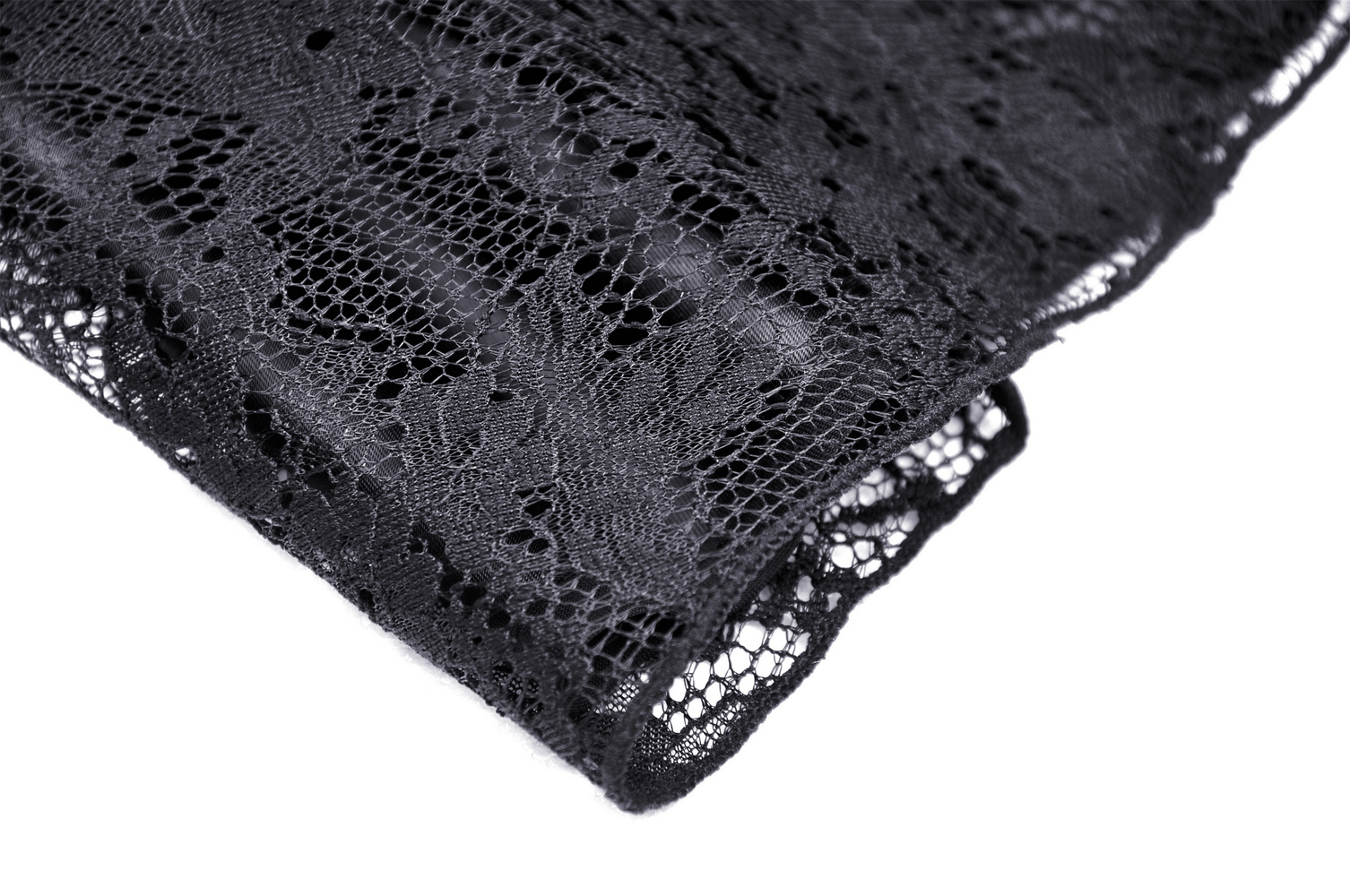 Close-up of delicate black lace fabric showcasing intricate patterns for gothic fashion designs.