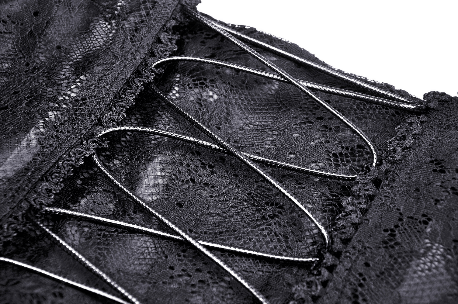 Close-up of intricate black lace and silver corset detailing on a gothic dress, perfect for a dark romantic look.