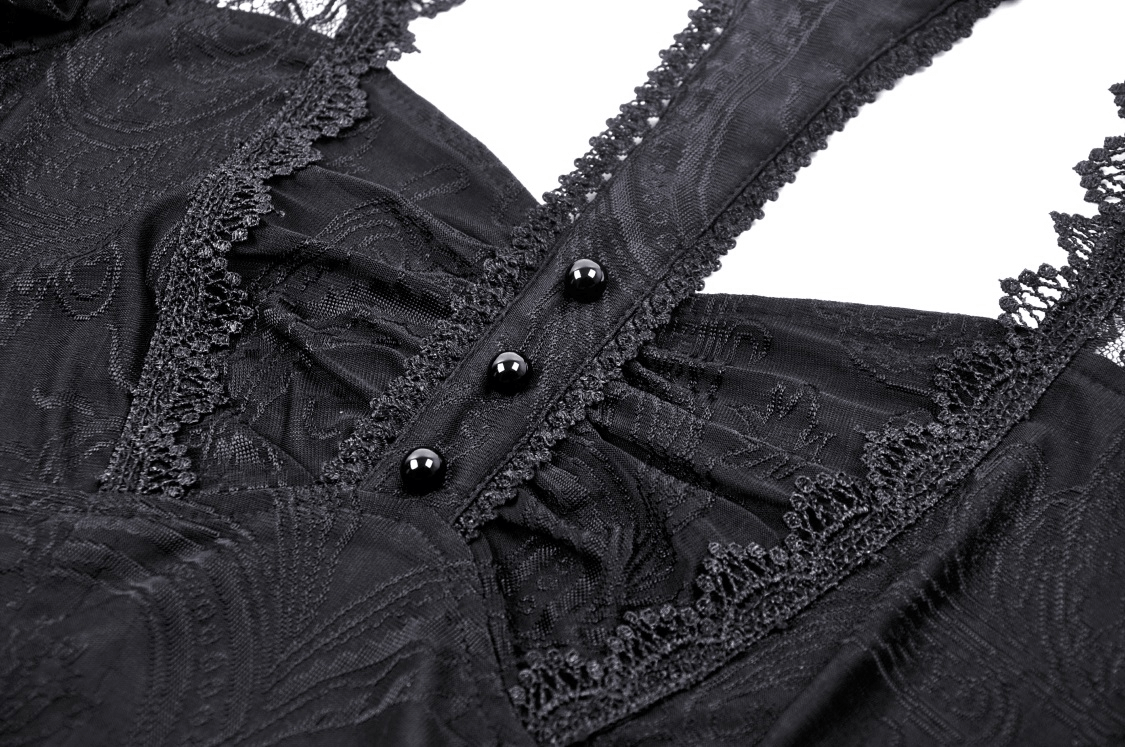 Close-up of black gothic lace top featuring intricate lace details and button accents.