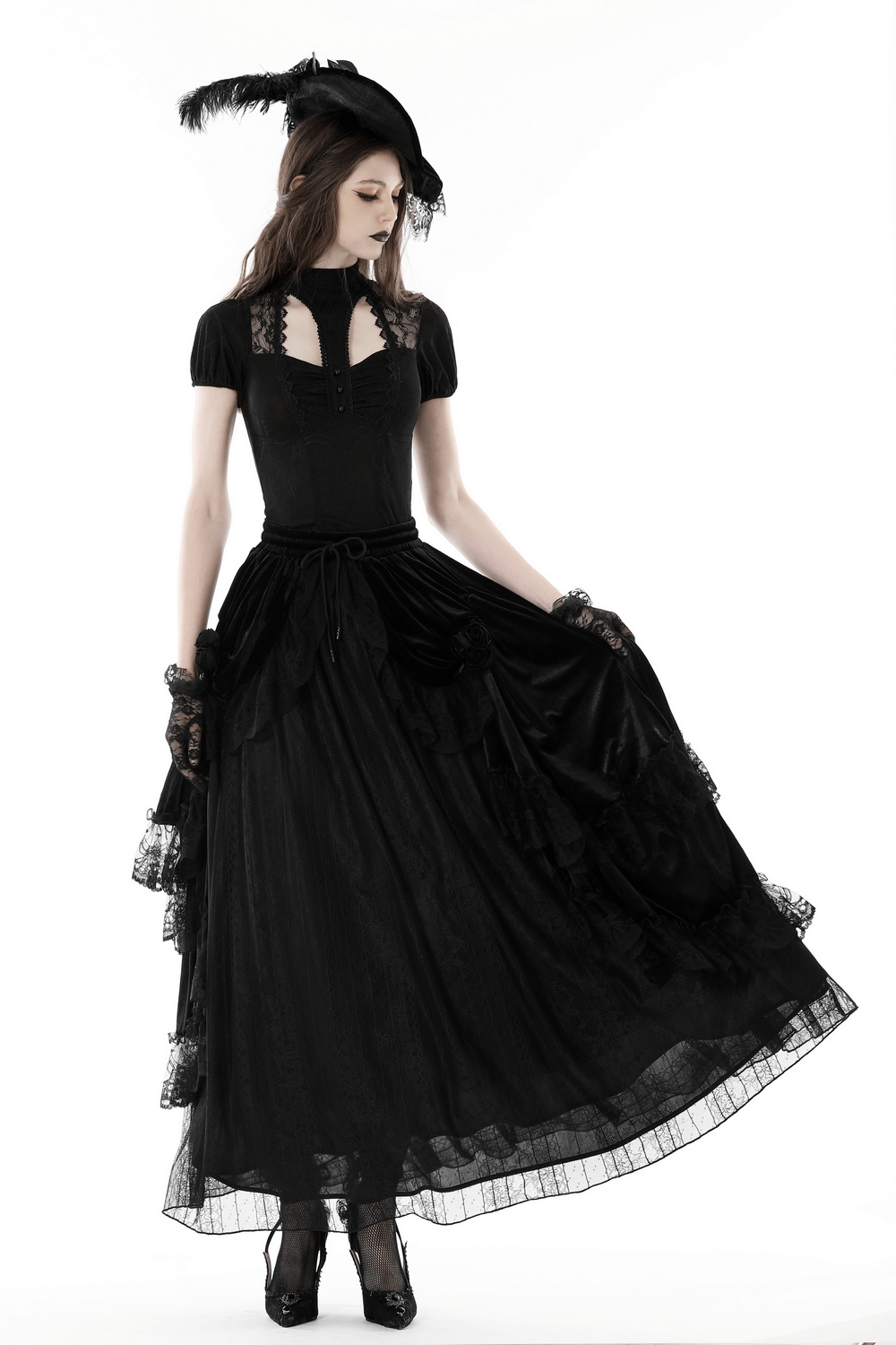 Gothic model in a black lace top and long black skirt, channeling dark romantic elegance with feathered hat.