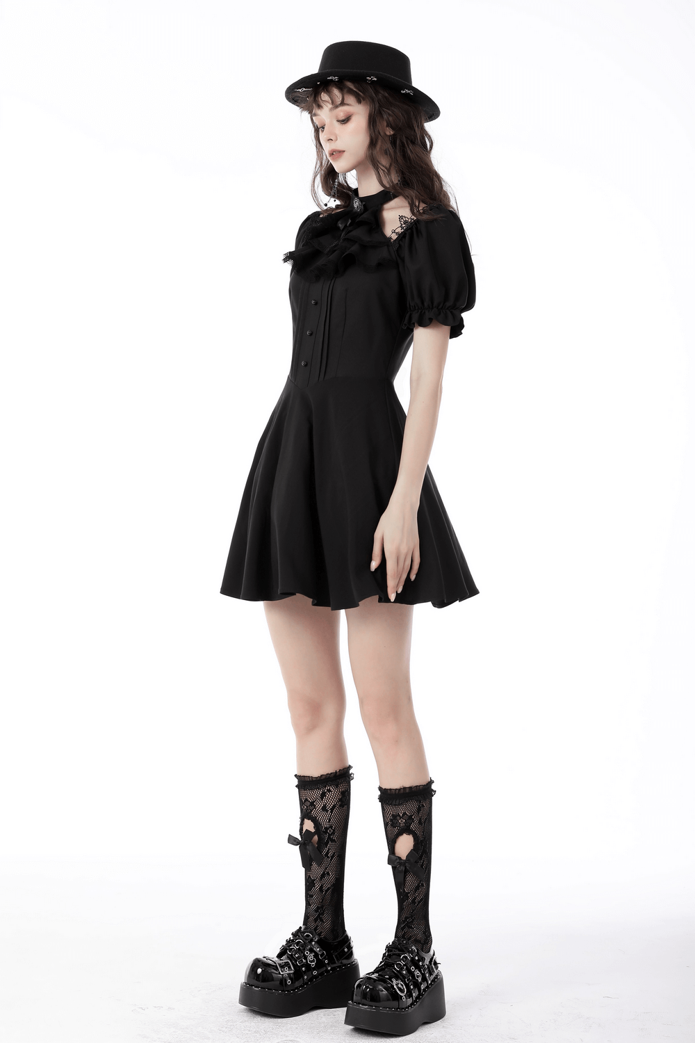 Model wearing a dark romantic gothic puff sleeve dress with ribbon bow, paired with a stylish hat and lace socks.