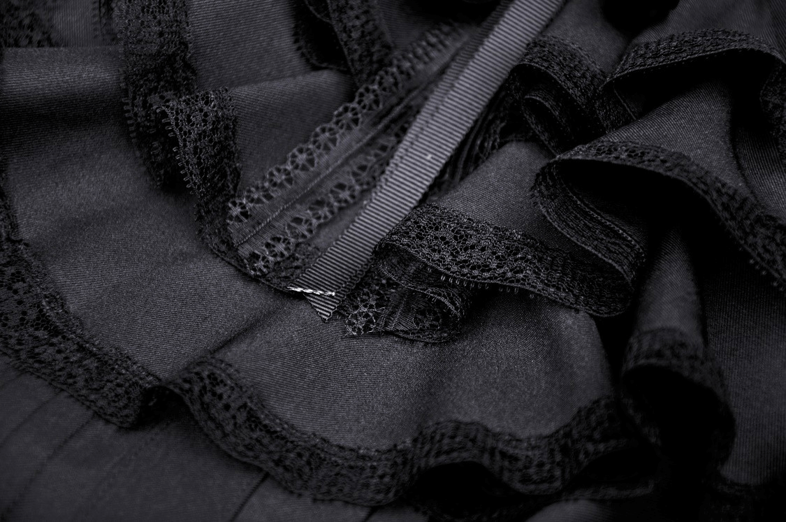 Close-up of black fabric with lace trim and ribbon, showcasing gothic style details for Puff Sleeve Dress.