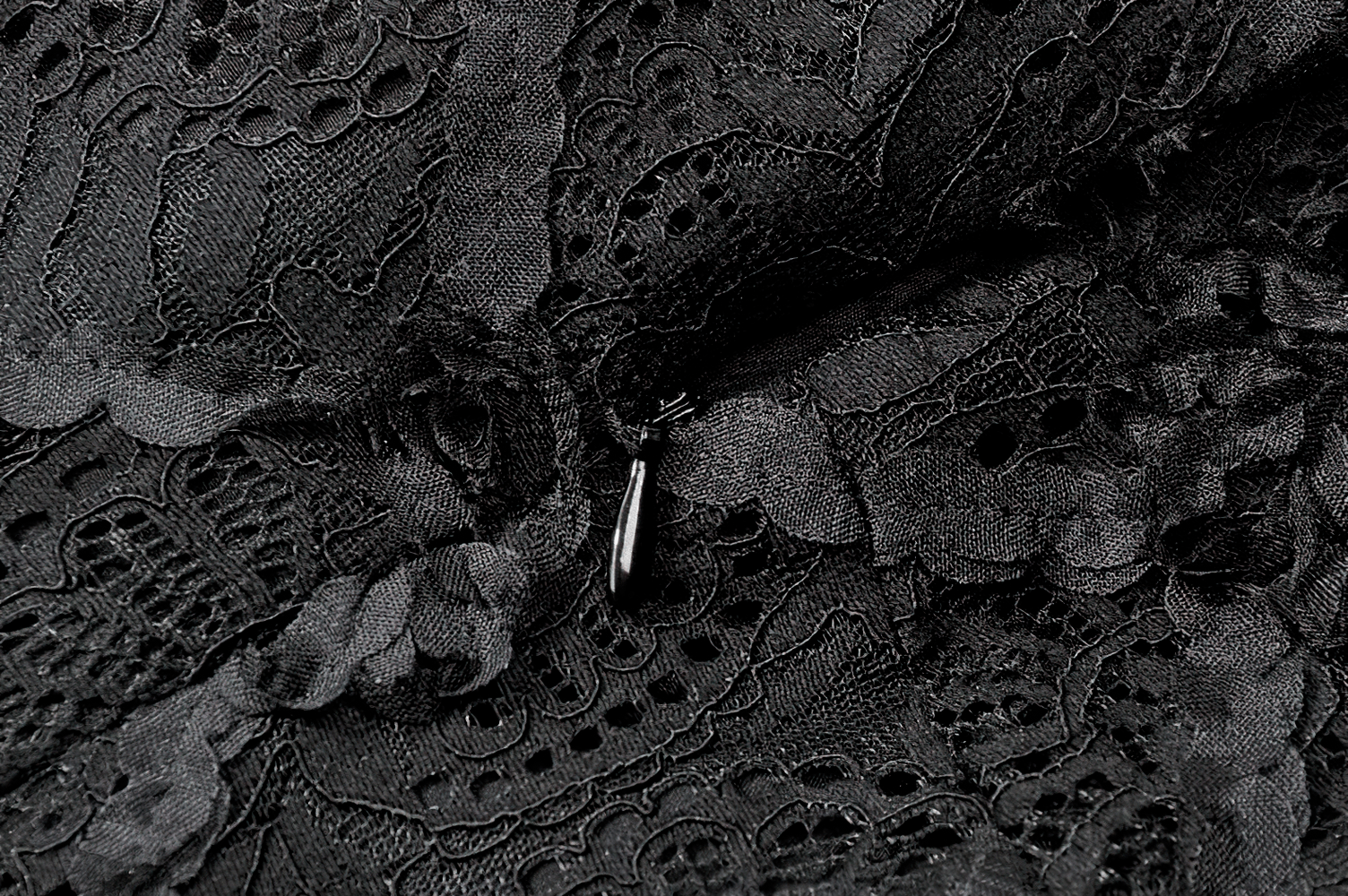 Dark Romantic Lace Mini Dress with Corset Waist and Cross detailed lace fabric close-up.