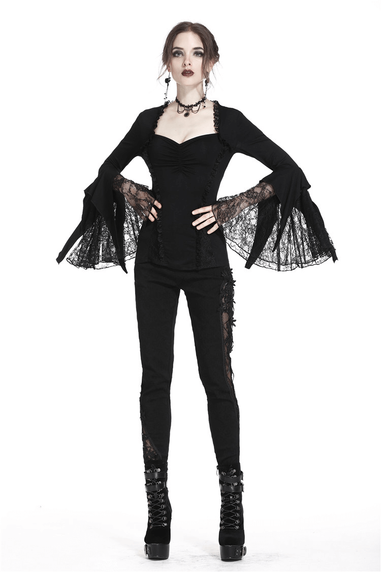 Dark lace top with flared sleeves, perfect for gothic and romantic styles, paired with black skinny jeans.
