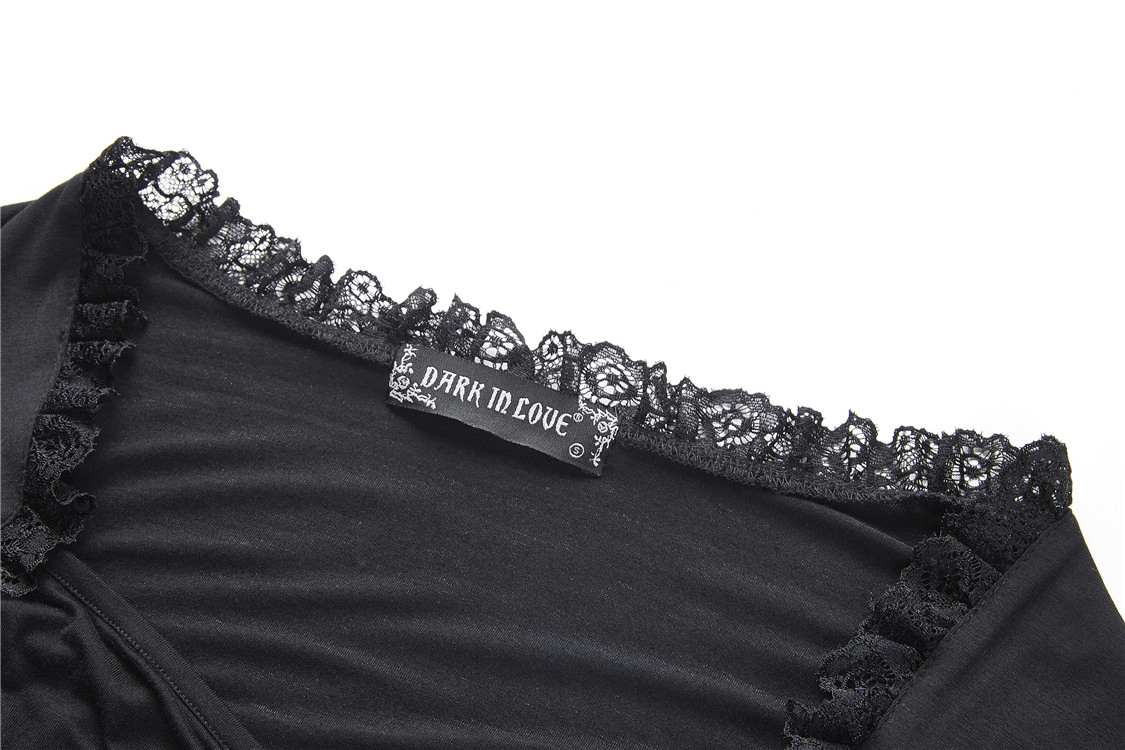 Black lace detail and label from a Dark Romantic Lace Top, showcasing intricate Victorian-style embellishments.