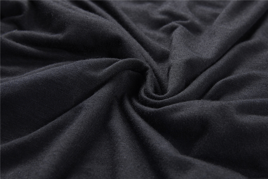 Close-up of soft black fabric, showcasing its luxurious texture and drape for a romantic lace top.
