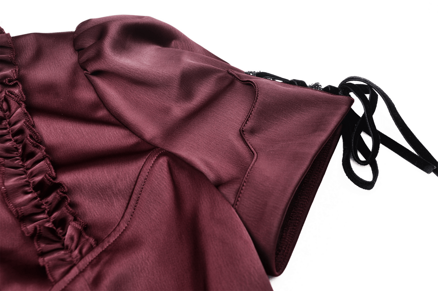 Close-up of dark romantic wine red blouse's dramatic puff sleeve and silky fabric details.