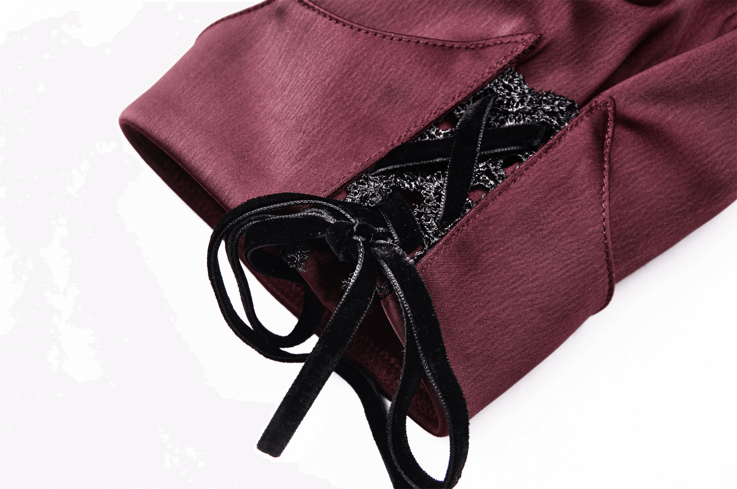 Detail of dark romantic wine red blouse with puff sleeves and lace-up accent, showcasing luxurious satin texture.