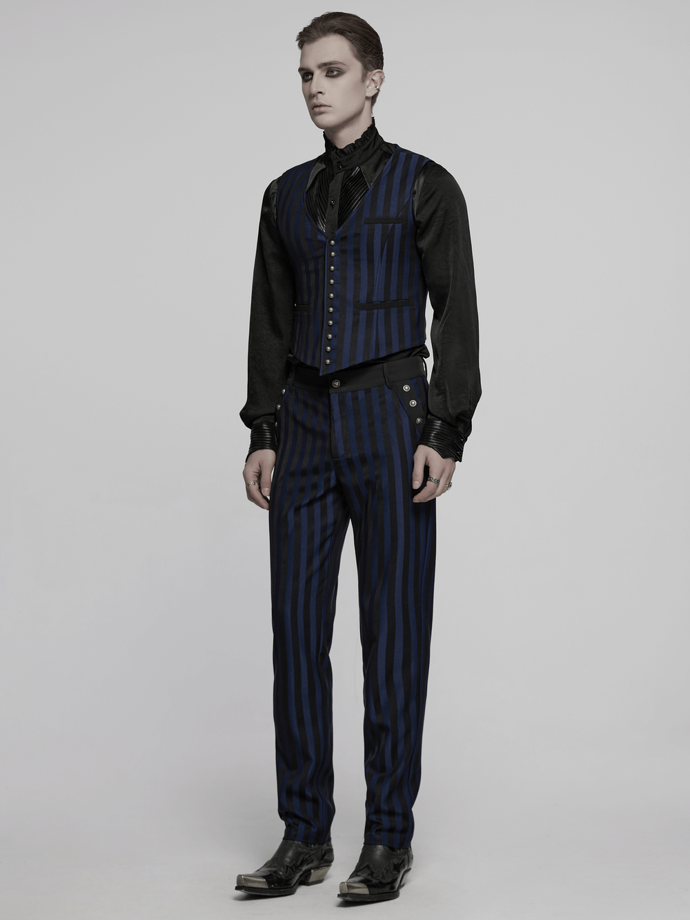 Gothic slim fit trousers with vertical stripes and buckles, styled elegantly for alternative menswear.