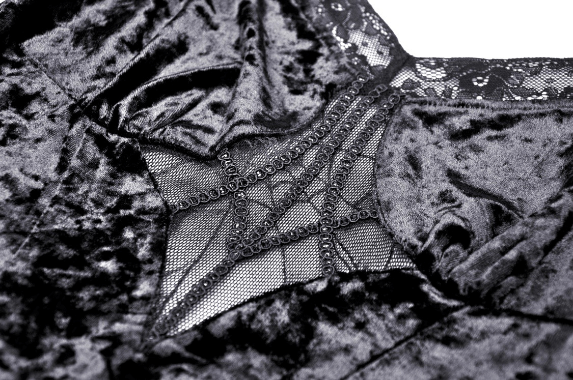 Close-up of dark velveteen fabric with intricate spiderweb lace detailing, perfect for gothic elegance.