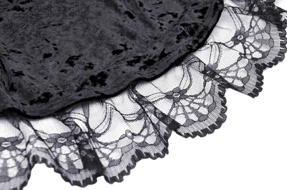 Close-up of black velveteen fabric and delicate spiderweb lace trim, perfect for gothic fashion.