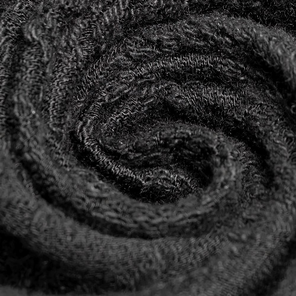 Close-up of dark black fabric swirling in a spiral pattern, showcasing its soft texture and intricate weave.