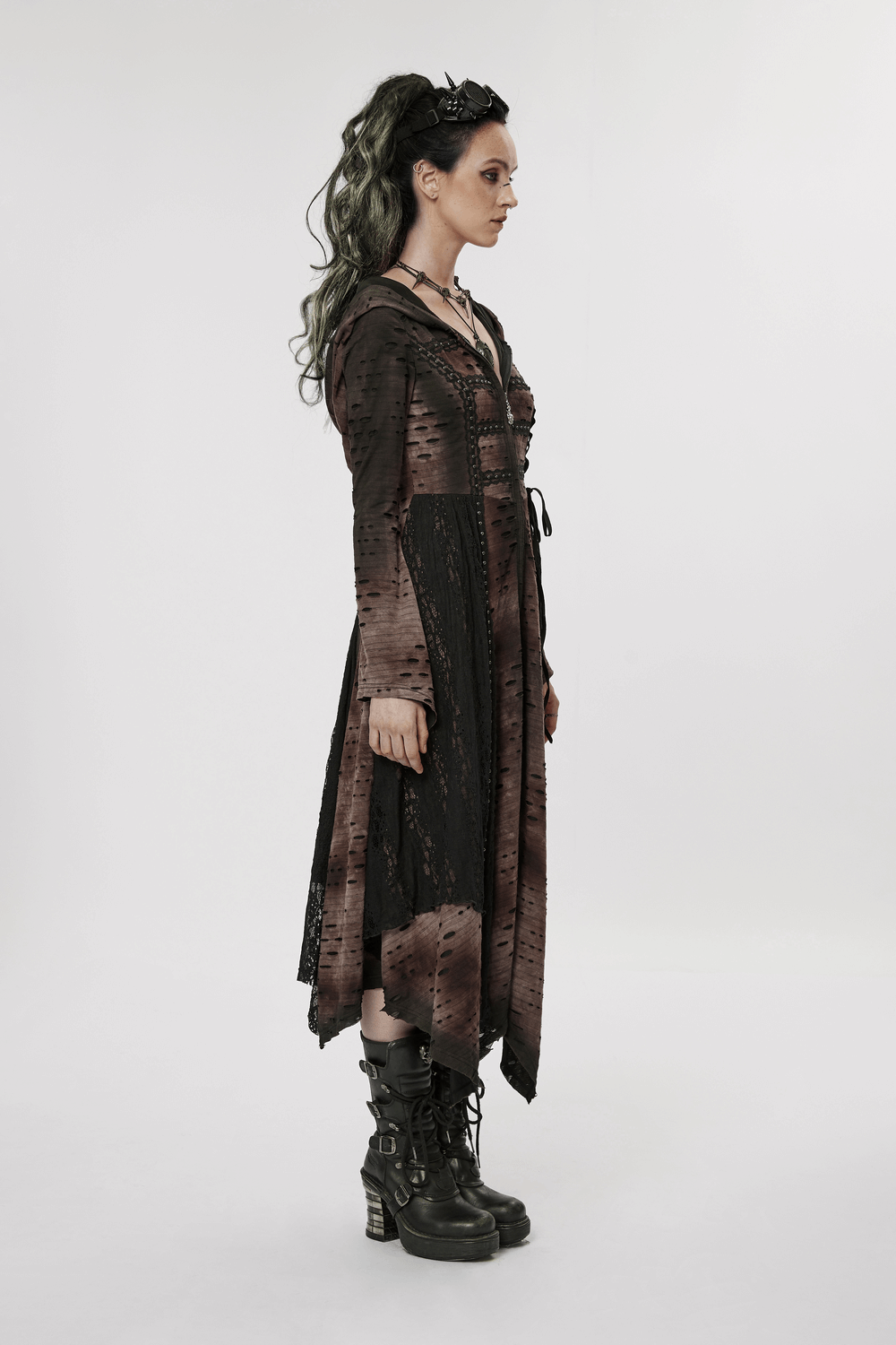 Dark wizard hooded long coat with irregular hem, adorned with rivets, worn by model showcasing gothic style.