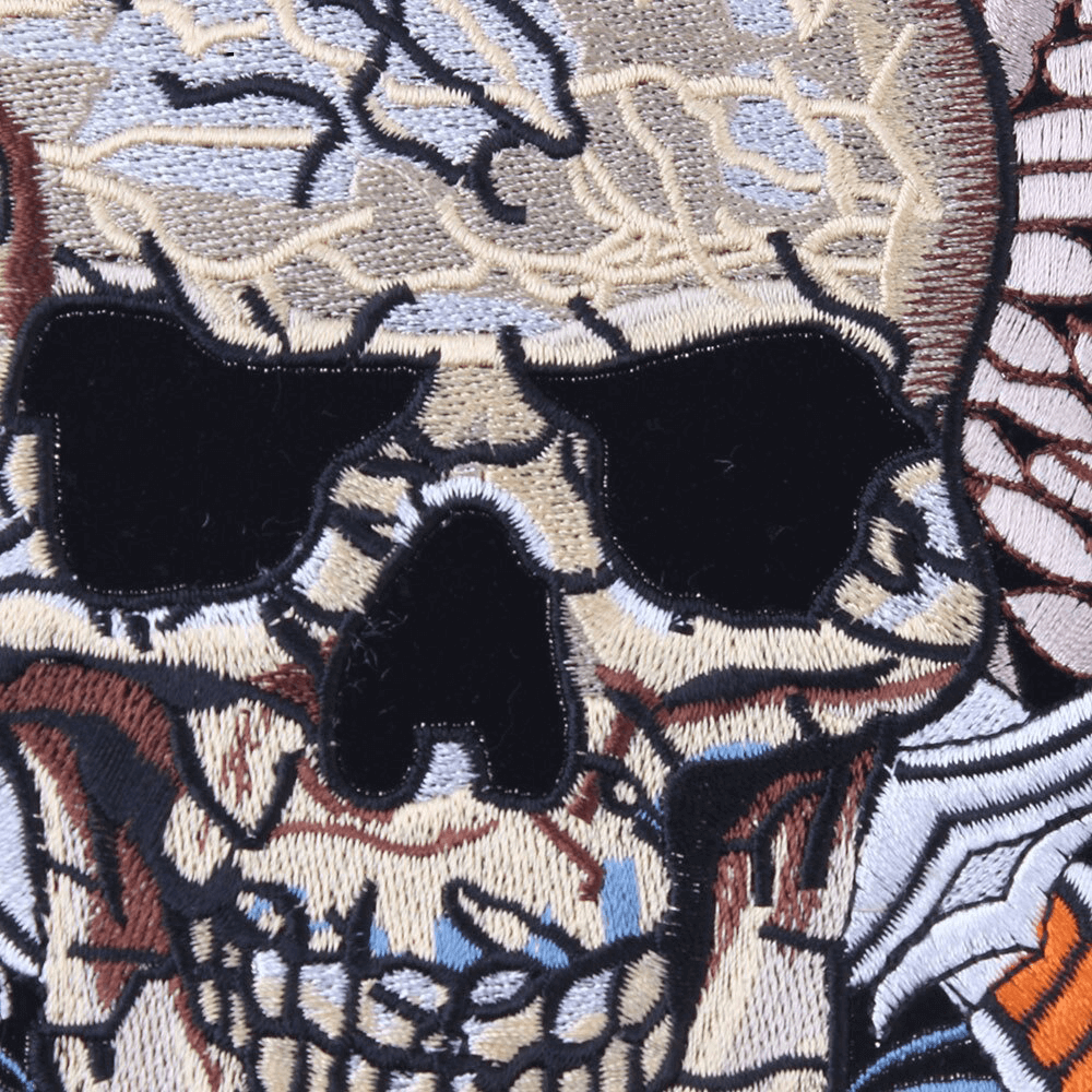 Detailed embroidered skull design with wings, perfect for biker jackets and patches.
