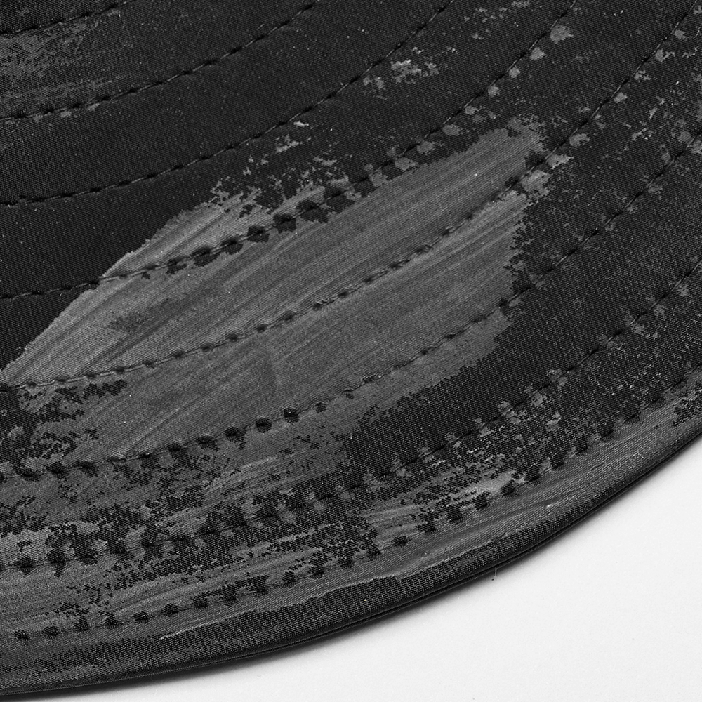 Close-up of the distressed woven brim of a rugged post-apocalyptic style hat, showcasing unique texture and details.