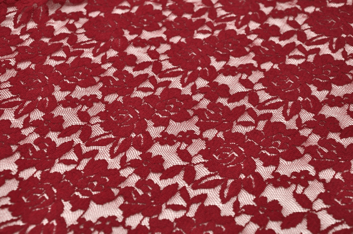 Deep red floral lace fabric with intricate rose patterns, perfect for elegant gothic fashion or dress details.