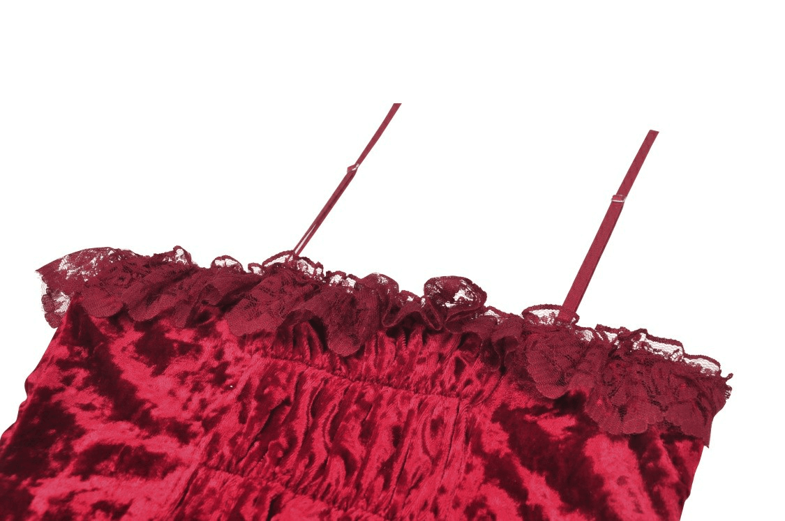 Close-up of deep red velvet dress featuring lace trim and delicate straps, embodying gothic elegance.