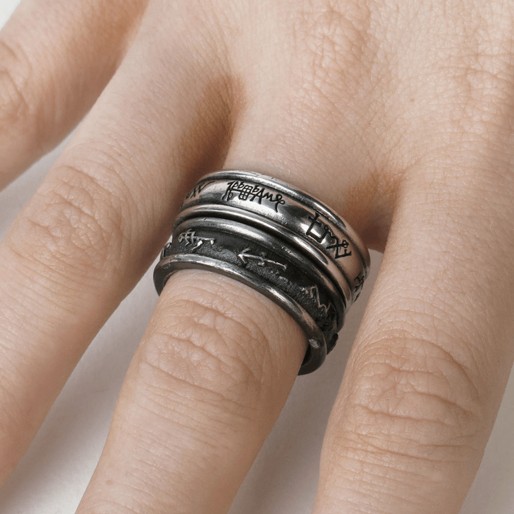 Demon black and angel white ring set with spirit signatures on a model's hand.