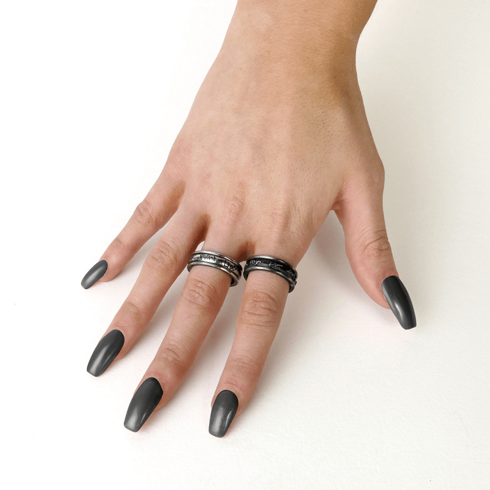 Hand wearing Demon Black and Angel White rings showcasing unique designs and spiritual engravings.