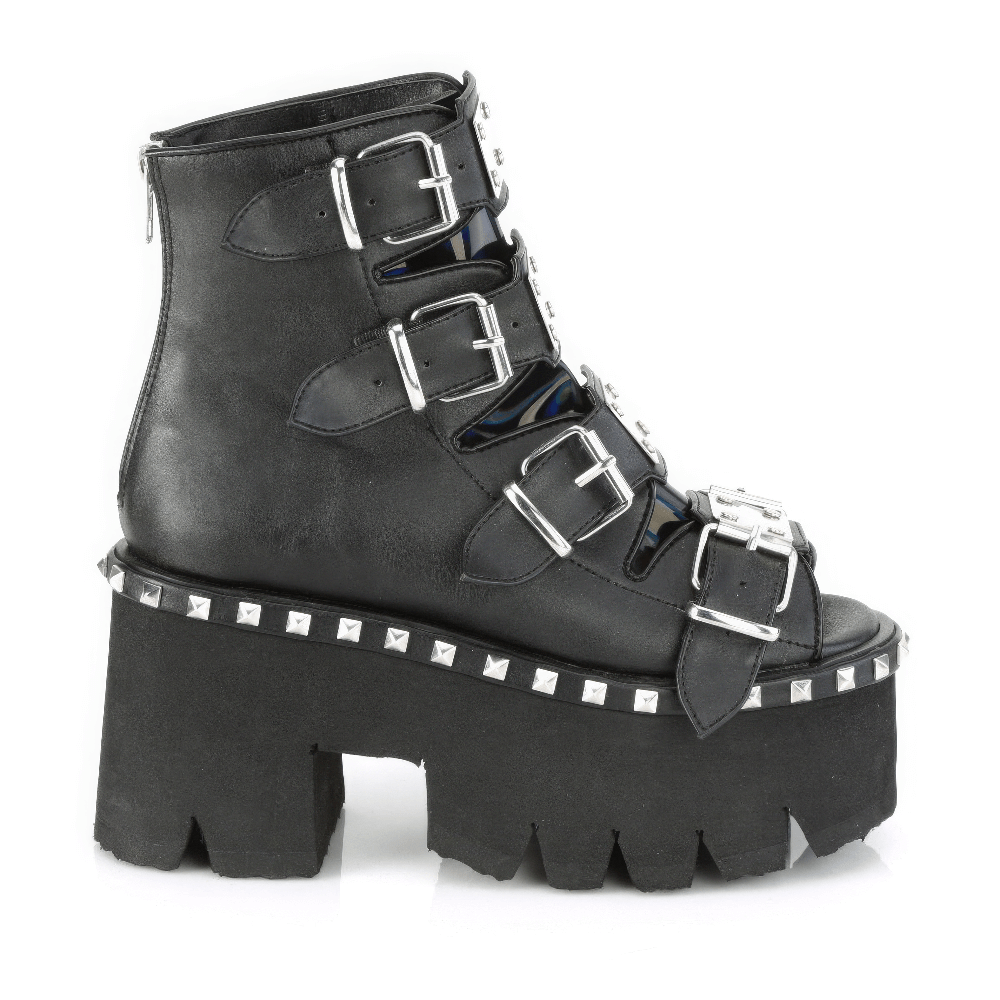Demonia black chunky heel bootie sandals with buckle straps and metal studs, featuring holographic details.