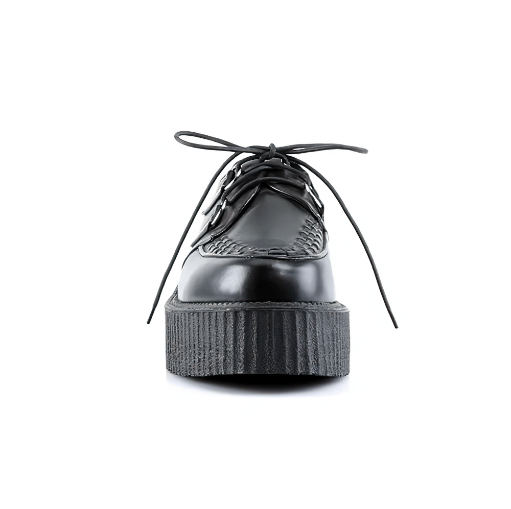 Front view of DEMONIA black vegan creeper shoes with 2-inch platform and woven detailing for punk fashion.