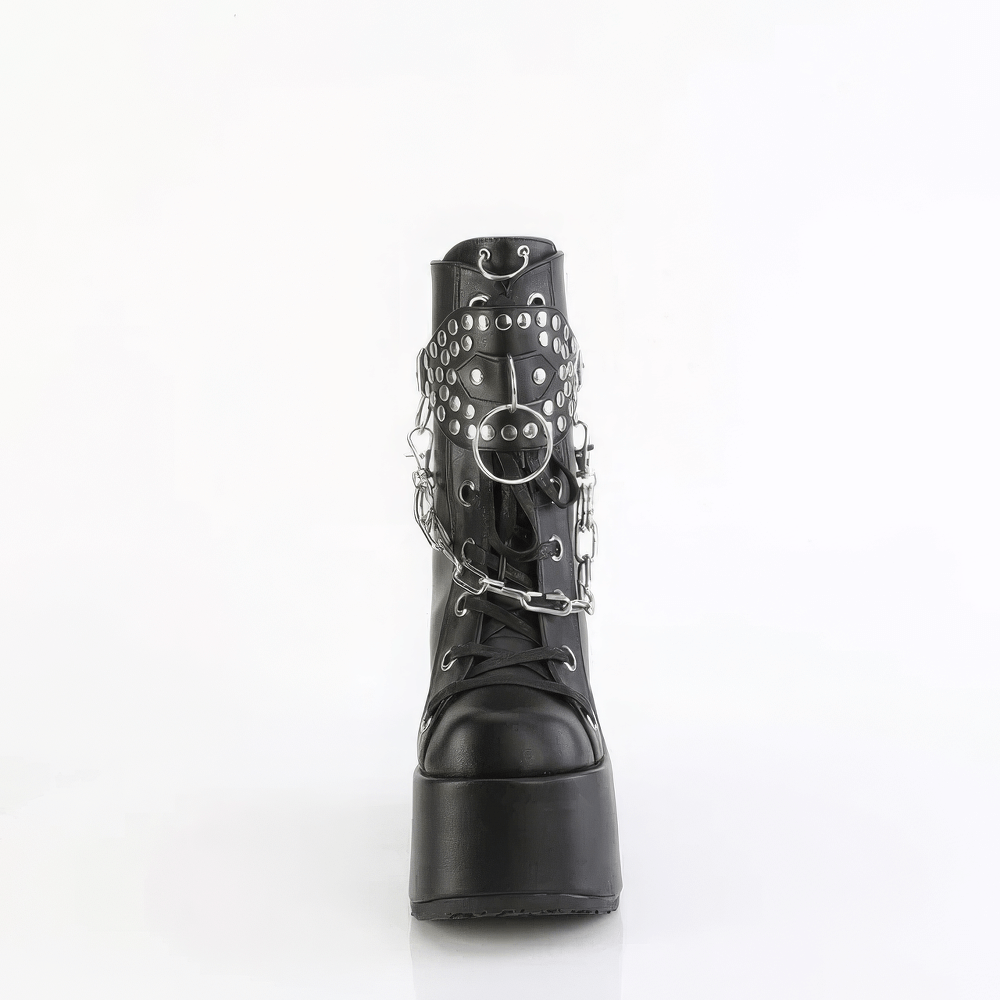 Bold DEMONIA mid-calf black platform boots with studded shield and removable chain detail.