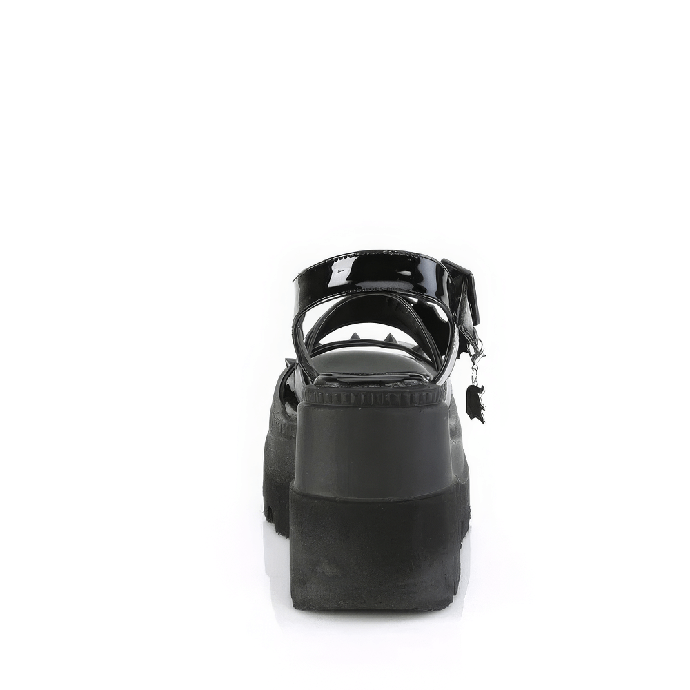 Back view of Demonia black patent platform sandals with cone studs and heart buckle, showcasing edgy style and height.