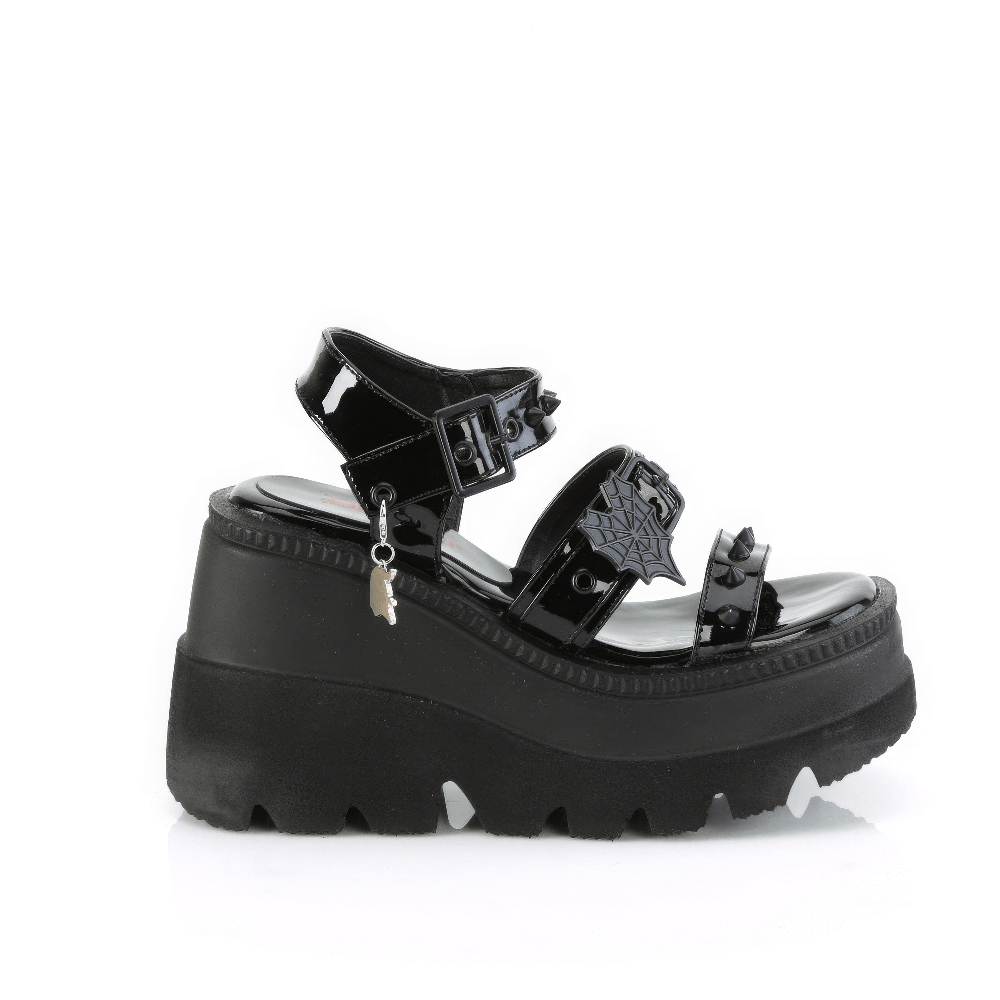 Demonia black patent platform sandals with cone-studded straps and heart buckle charm.