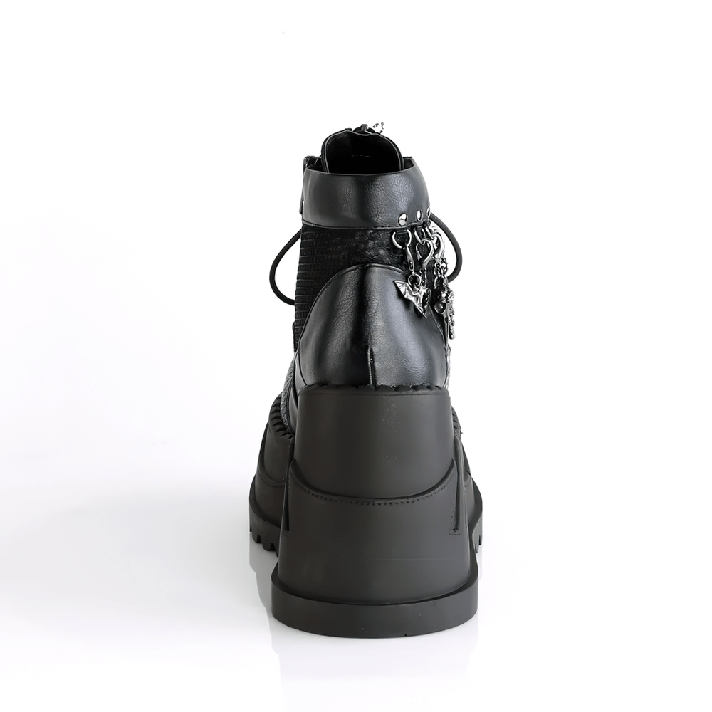 Back view of DEMONIA black platform booties with charms and eyelets, showcasing edgy lace-up design and fishnet overlay.