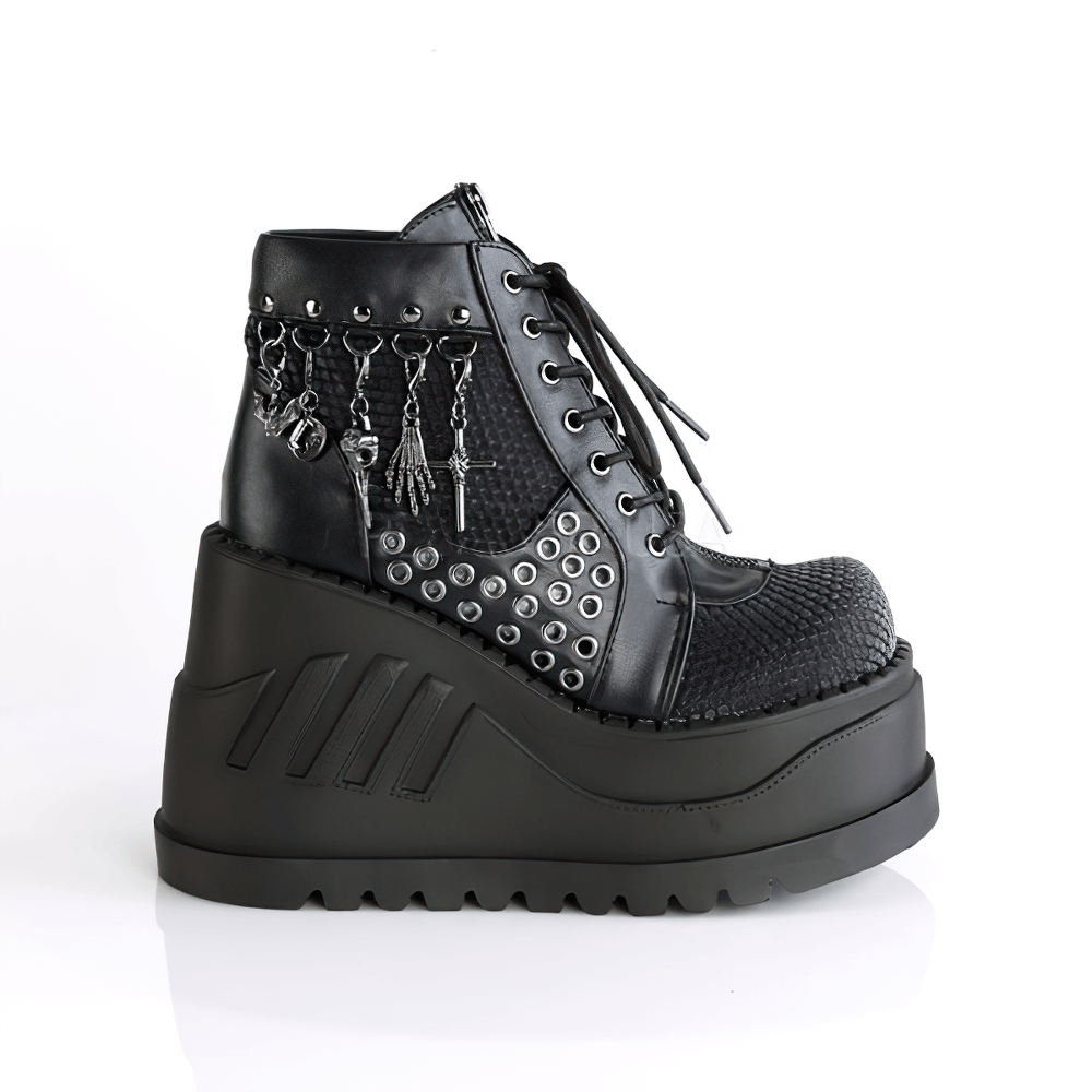 Demonia black platform booties with charms, eyelets, and fishnet overlay, showcasing edgy lace-up style and bold 4.75" height.